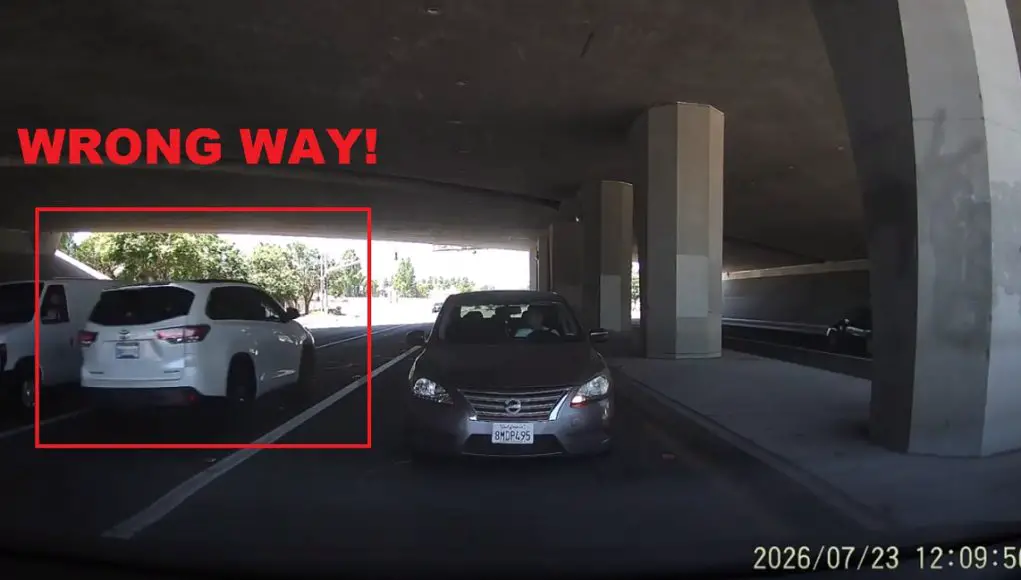 Old lady driver gets confused turning left onto Chino Hills Parkway. Drives against oncoming traffic.