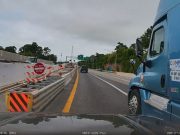 Distracted Semi truck driver on I-64 drifts into wrong lane, almost sandwiches driver into side of freeway.
