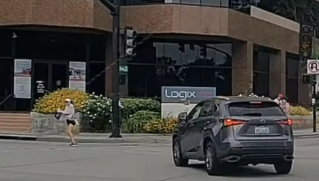 Ignorant driver turning onto First from Olive nearly plows through pedestrian trying to cross.